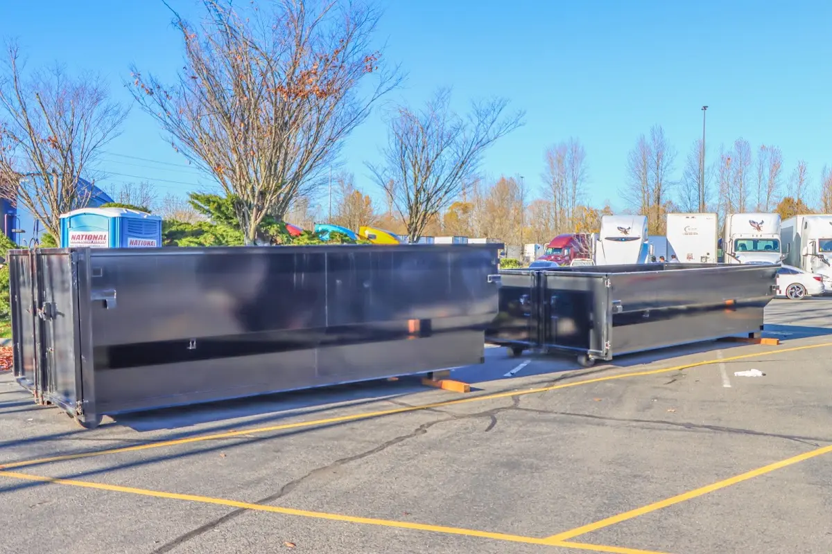 Professional dumpster rental service with roll-off container on residential driveway in Lake Forest Park